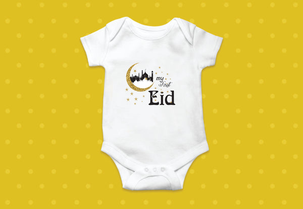 My First Eid" onesie, adorned with colorful illustrations of crescent moons, stars, and Eid Mubarak greetings