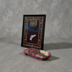 A4-sized black carved frame featuring gold “Fiddunya Wal Aakhira” calligraphy with an elegant couple hand illustration, luxury Islamic wedding decor.