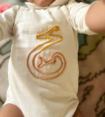 Custom embroidered onesie with Arabic name, personalized baby clothing, unique gift for newborns, soft cotton fabric, onesie with intricate stitching.