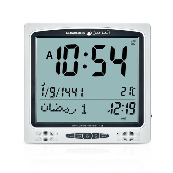 Al-Harameen Azan Clock HA-7009 with digital display, showing prayer times, and featuring adjustable volume control. The clock has a simple setup based on area code and dimensions of 24.5 x 23.5 cm.